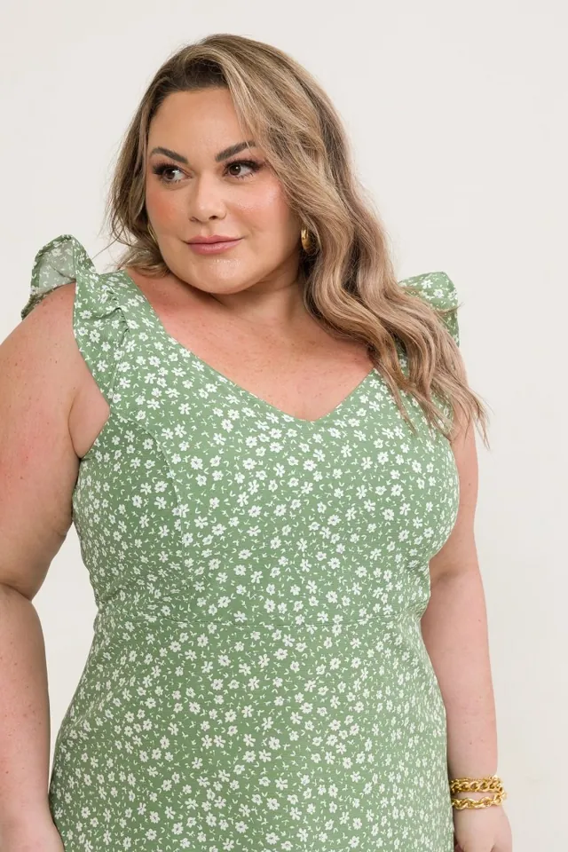 Plus size model wearing a green floral dress