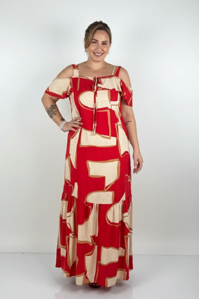 Plus size model wearing a long red and cream printed dress